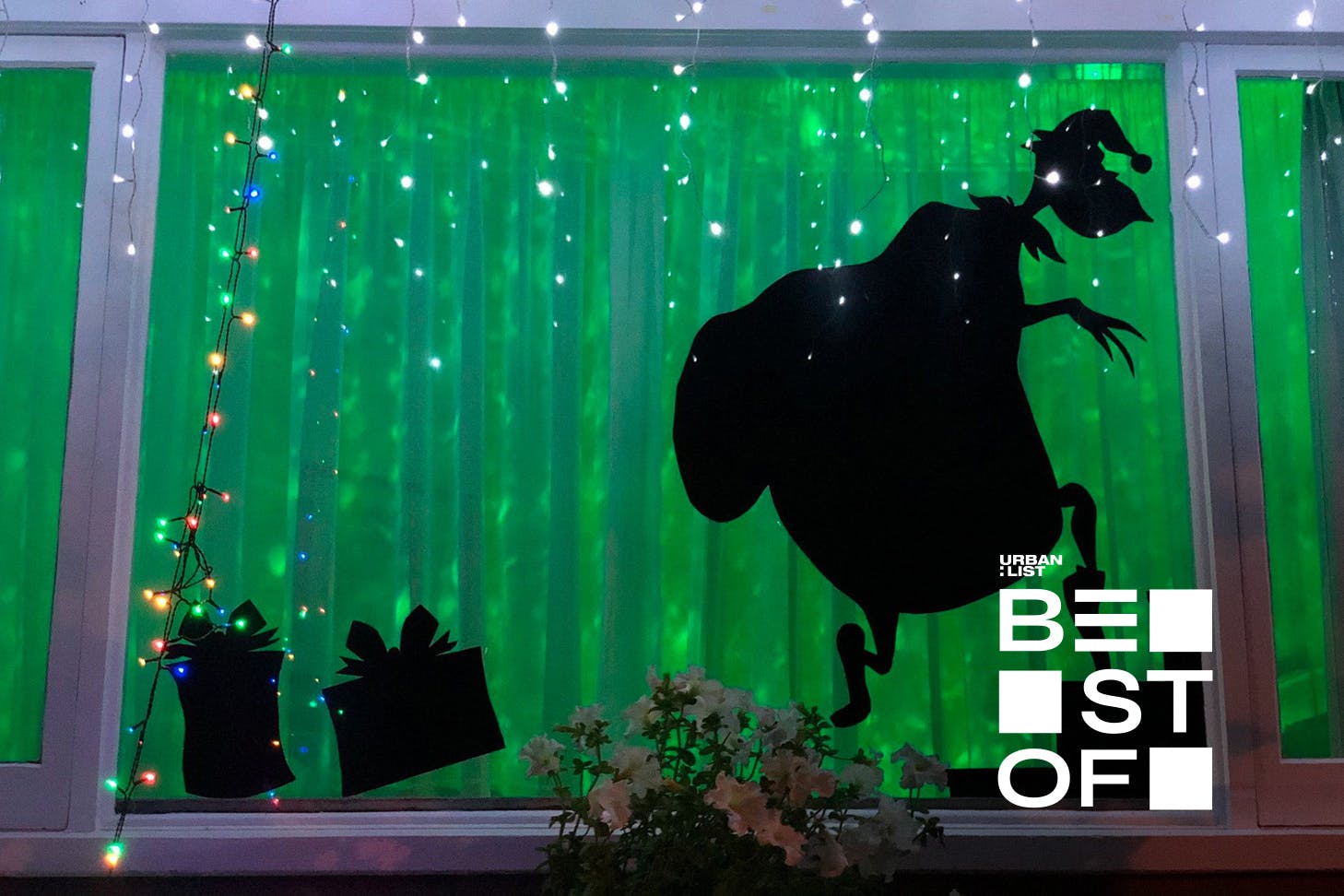The Grinch creeps across the window on Franklin Road, one of the best places in Auckland to see Christmas lights.